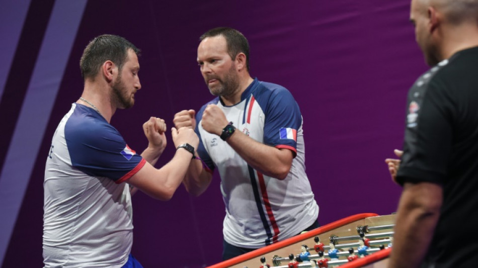 Players twist for glory at the table football World Cup