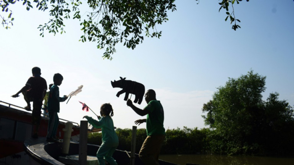 Indonesian uses puppets to teach threat to world's rarest rhinos