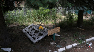 In Ukraine's Siversk, a grave dug on a sidewalk